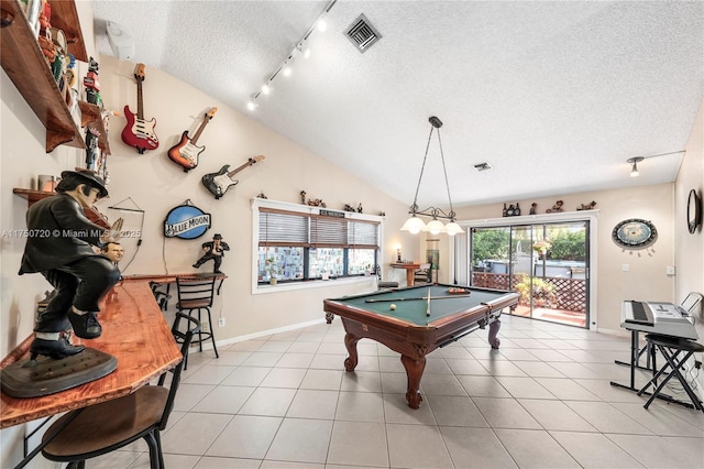 game room with light tile patterned floors, baseboards, visible vents, vaulted ceiling, and a textured ceiling