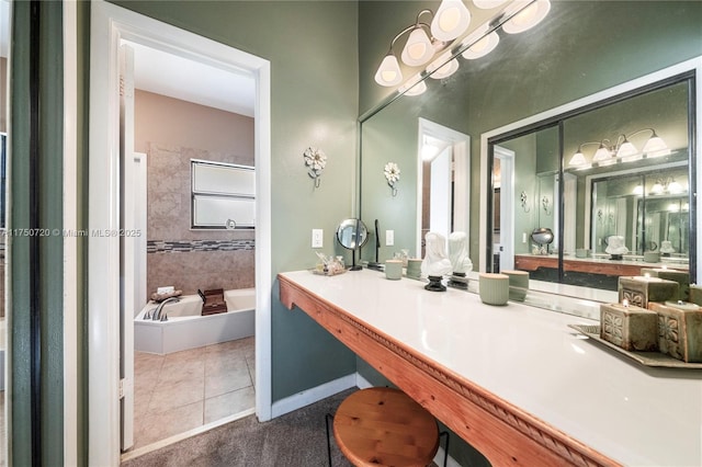 bathroom with baseboards, a notable chandelier, a bathing tub, tile patterned flooring, and vanity