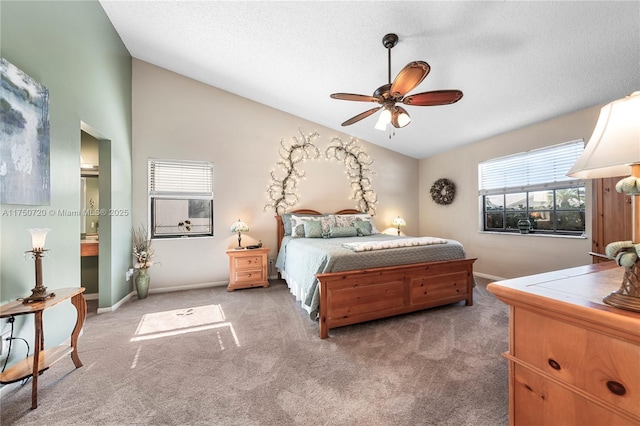 bedroom with lofted ceiling, baseboards, a textured ceiling, and light colored carpet