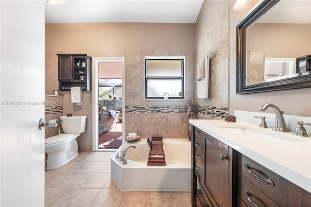 full bathroom with tile patterned flooring, a bath, toilet, and vanity