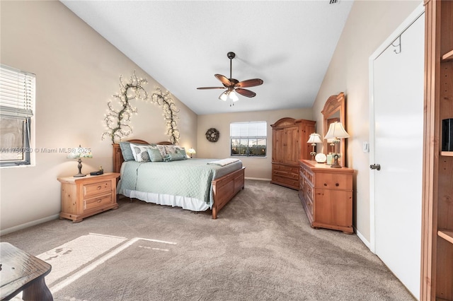 bedroom featuring vaulted ceiling, light carpet, and baseboards