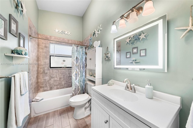 bathroom with vanity, wood finished floors, toilet, and shower / tub combo with curtain