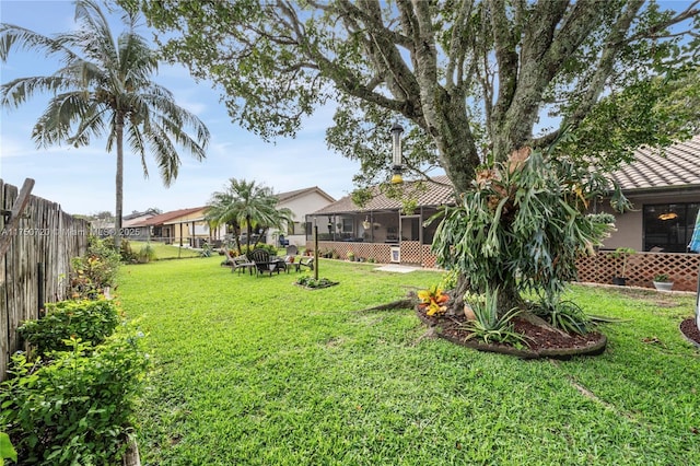 view of yard with a sunroom and a fenced backyard