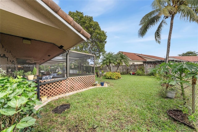 view of yard with a fenced backyard and a lanai