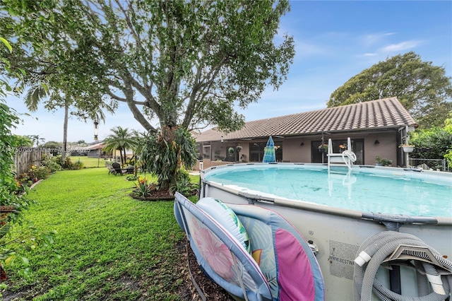 view of swimming pool with a fenced backyard, a fenced in pool, and a lawn