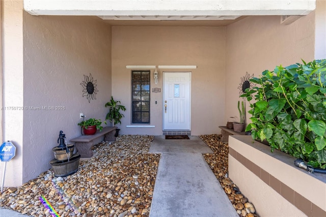 property entrance featuring stucco siding