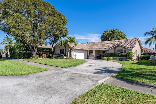 ranch-style house featuring a tiled roof, an attached garage, driveway, and a front lawn