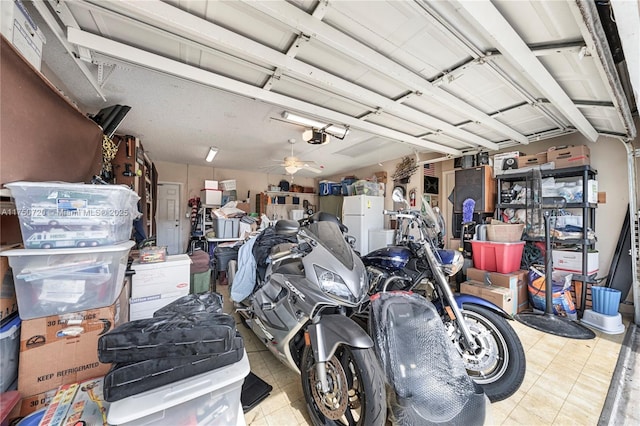 garage with ceiling fan, freestanding refrigerator, and a garage door opener