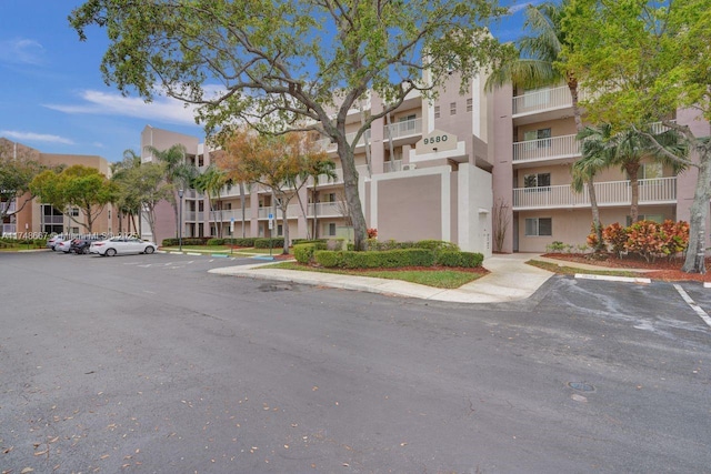 view of property with uncovered parking and a residential view