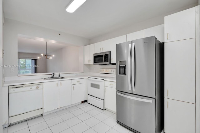 kitchen with white cabinets, stainless steel appliances, a sink, and light countertops