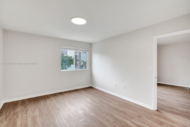 empty room with wood finished floors and baseboards