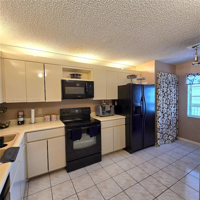 kitchen featuring a textured ceiling, white cabinetry, and black appliances
