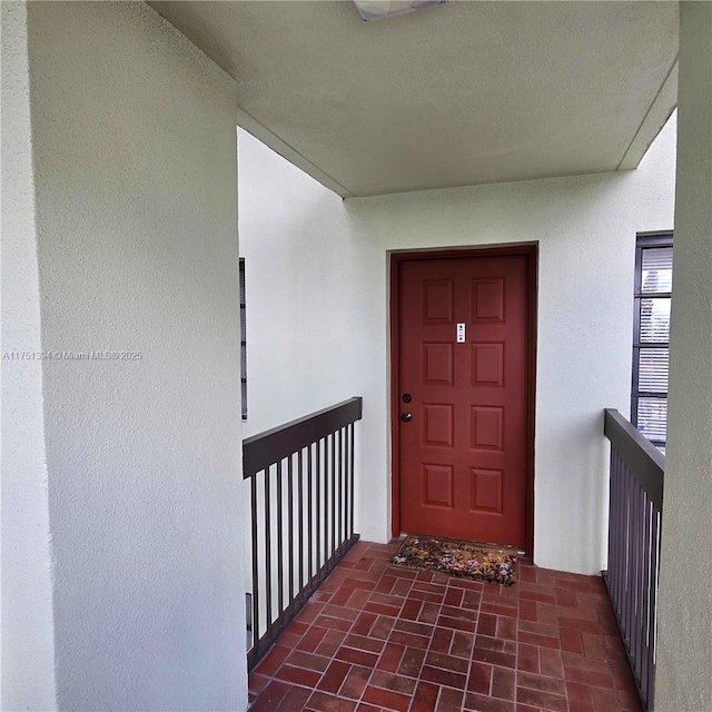 property entrance featuring stucco siding