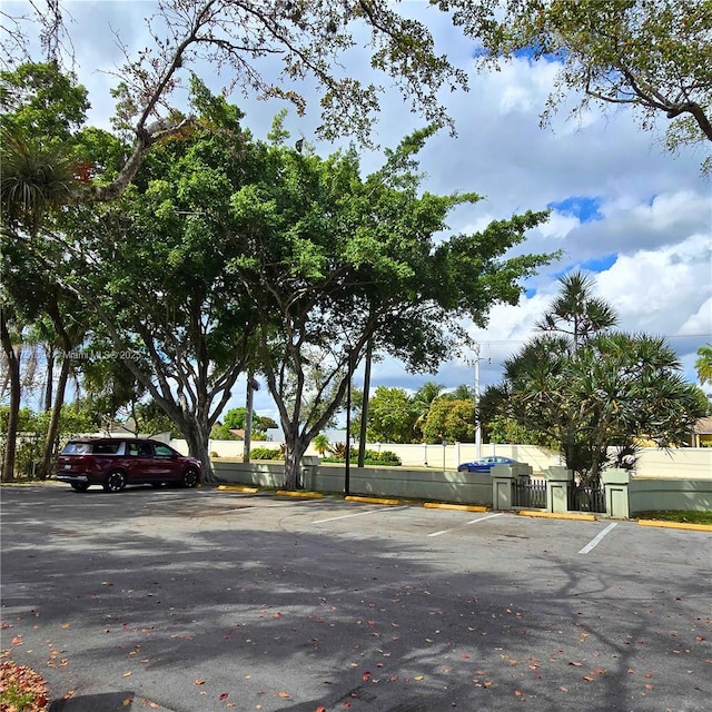 uncovered parking lot featuring fence