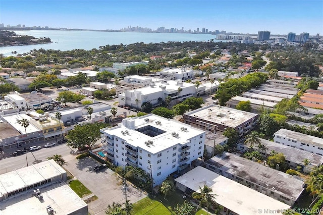 birds eye view of property with a view of city and a water view