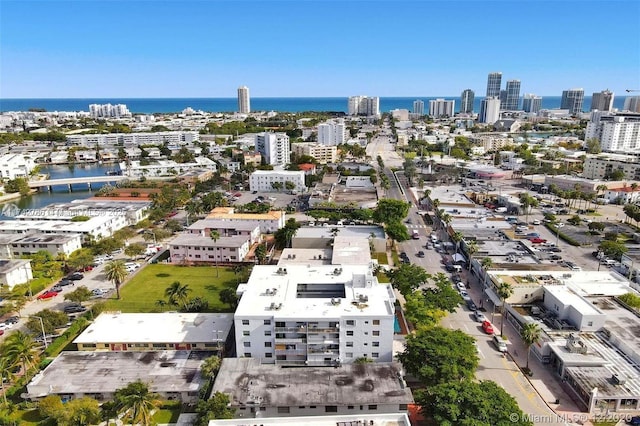 birds eye view of property featuring a view of city and a water view