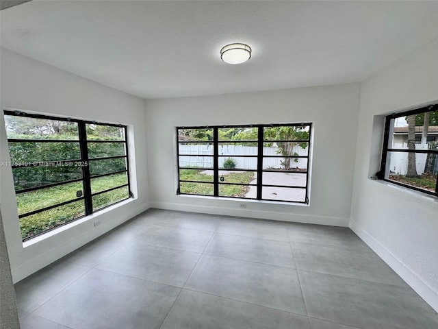 unfurnished room featuring baseboards