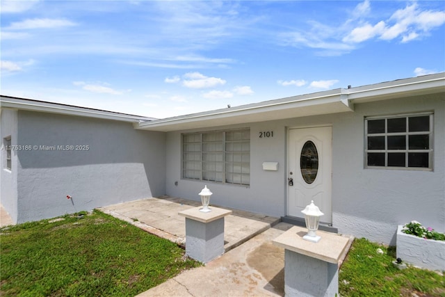 doorway to property with stucco siding