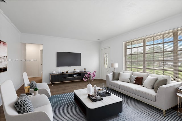 living area with ornamental molding, wood finished floors, and baseboards