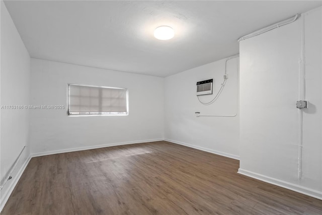 unfurnished room featuring baseboards and wood finished floors