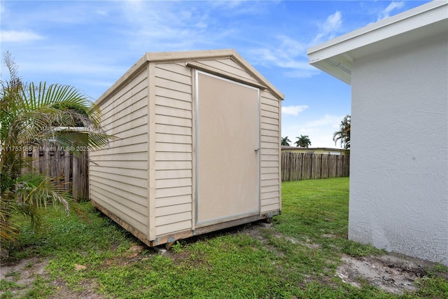 view of shed featuring fence