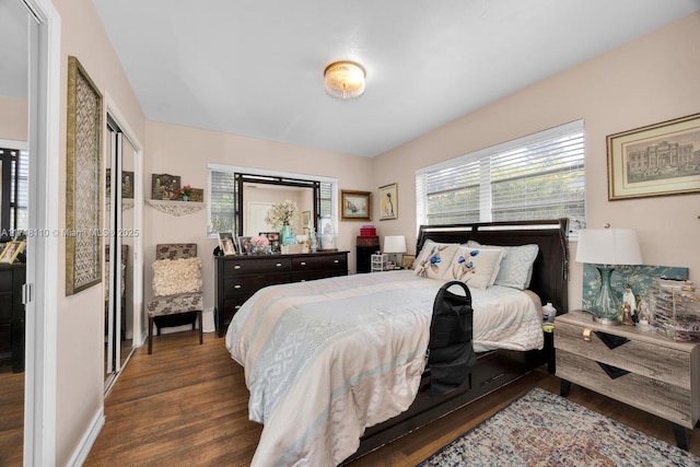 bedroom featuring baseboards and wood finished floors