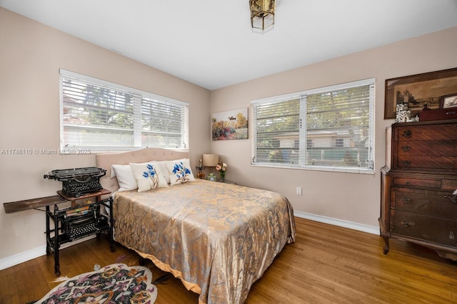 bedroom with wood finished floors and baseboards