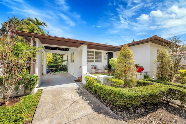 view of front of home featuring a carport and stucco siding