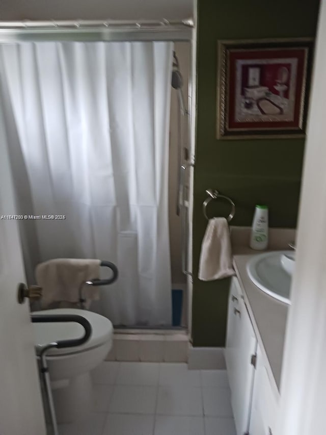 full bath with a stall shower, tile patterned flooring, vanity, and toilet