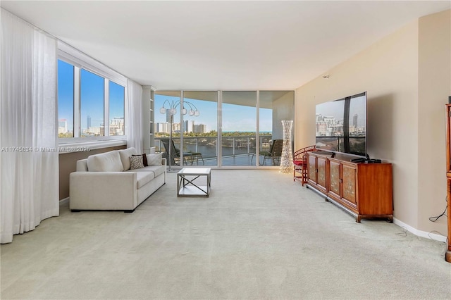 living room with floor to ceiling windows, carpet, and baseboards