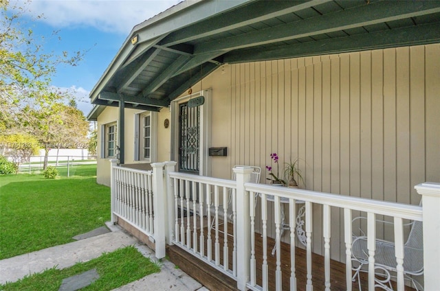 doorway to property with a lawn