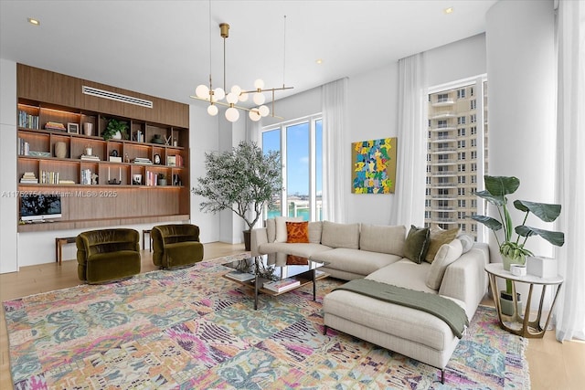 living room featuring wood finished floors and a notable chandelier