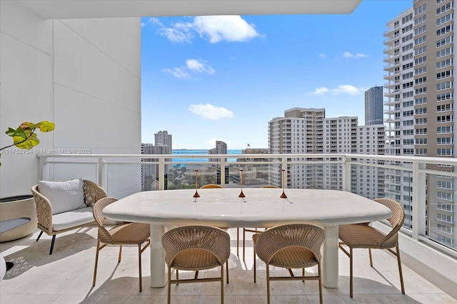 balcony featuring a water view and a city view