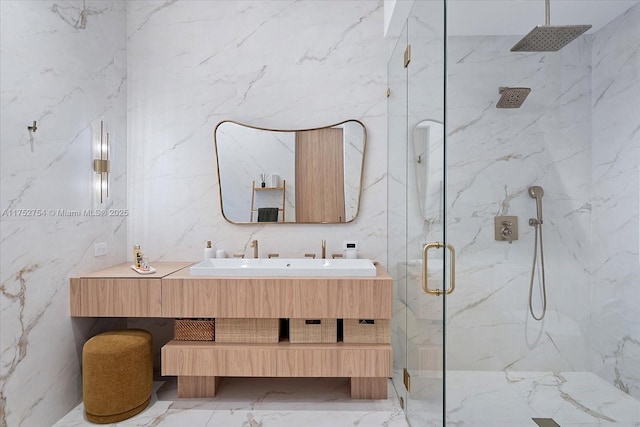 full bath featuring marble finish floor, a marble finish shower, and stone wall