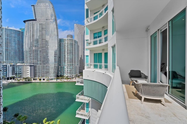 balcony featuring a city view and a water view