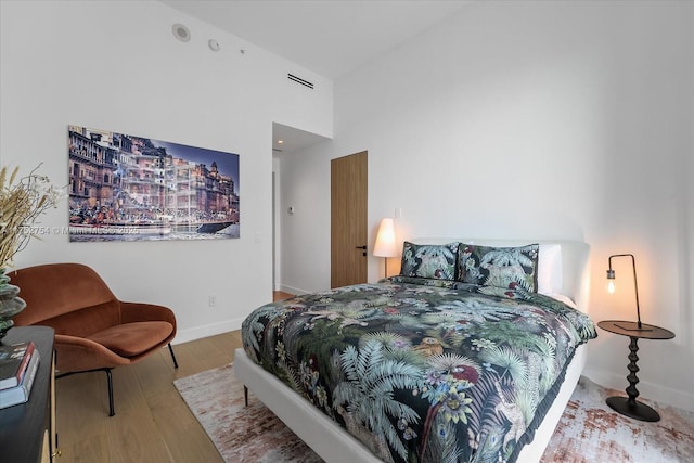 bedroom featuring baseboards and wood finished floors