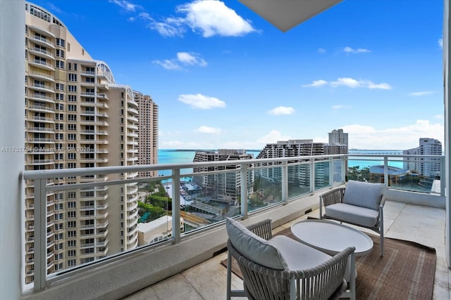 balcony with a water view and a city view