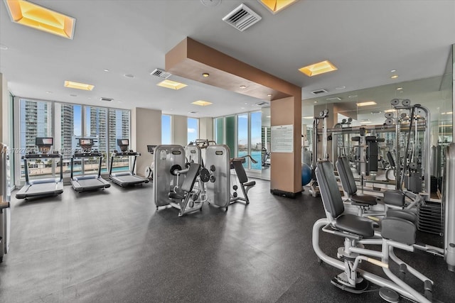 exercise room featuring visible vents and a wall of windows