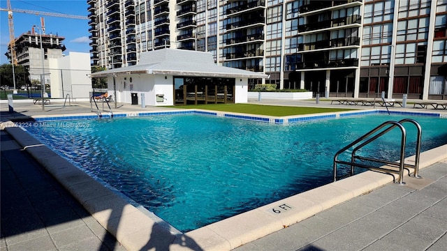 pool featuring a patio area and fence