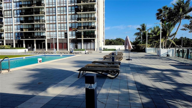 view of swimming pool featuring fence