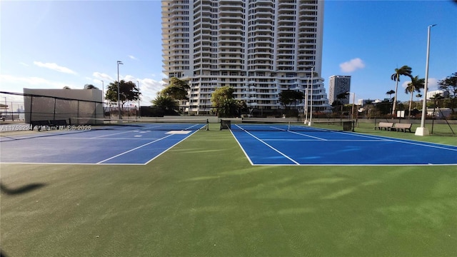 view of tennis court with fence