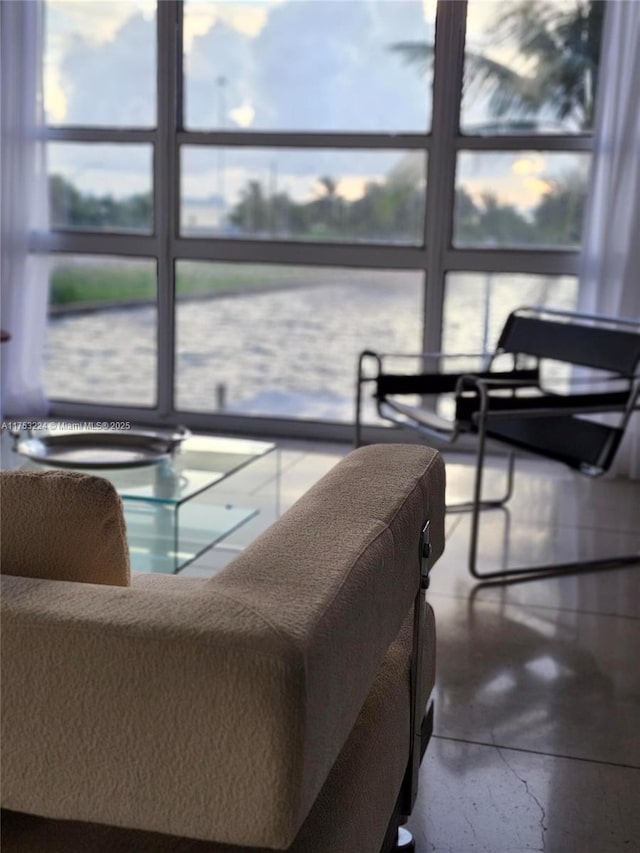 interior space featuring floor to ceiling windows and concrete flooring