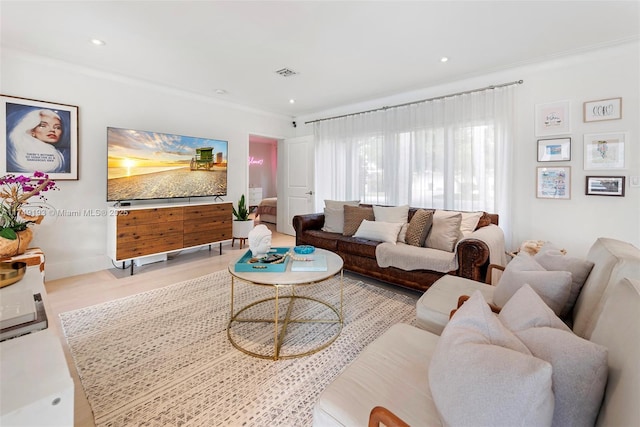 living room featuring recessed lighting, visible vents, and crown molding