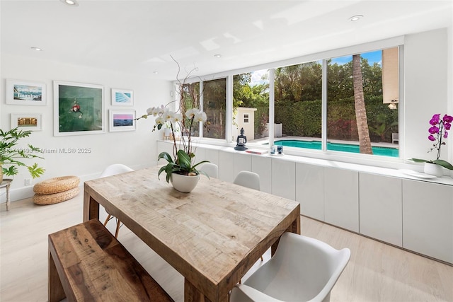 dining area with recessed lighting and light wood-style floors