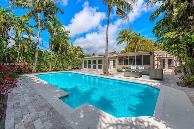 outdoor pool featuring french doors, outdoor lounge area, and a patio