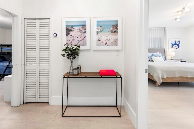 bedroom featuring a closet, baseboards, and wood finished floors