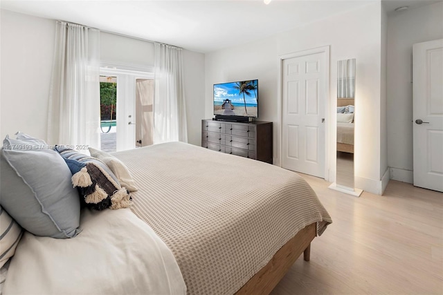 bedroom featuring light wood-type flooring and access to exterior