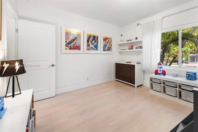 interior space featuring light wood finished floors and baseboards