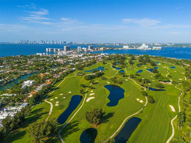 drone / aerial view featuring a water view, a city view, and golf course view