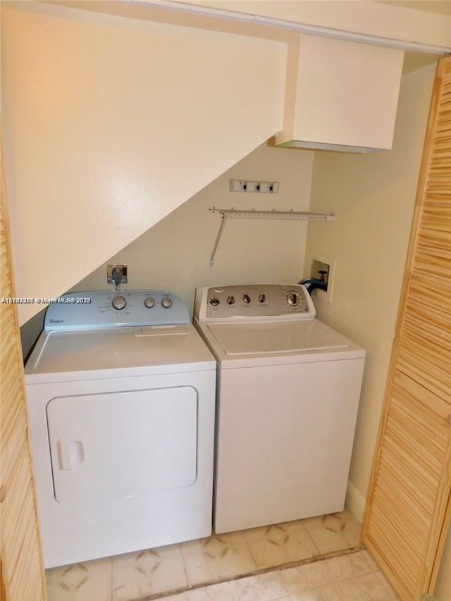 clothes washing area featuring laundry area and washing machine and clothes dryer